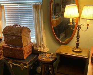 More trunks and wicker baskets
Antique oval mirror 
Night stand
Brass lamp
Wooden stool