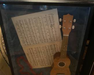 ukulele, framed with Hawaiian  souvenirs