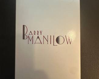 This Barry Manilow CD set is a collector's edition, including "The Complete Collection And Then Some" in a silver tall/DVD case. The set also includes a book and VHS, making it perfect for fans of Manilow's 1970s and 1980s pop rock and easy listening style. The record label is Collectables. The set was released in 1992 in the United States and features music in the English language. This is a great addition to any music collection for any occasion.