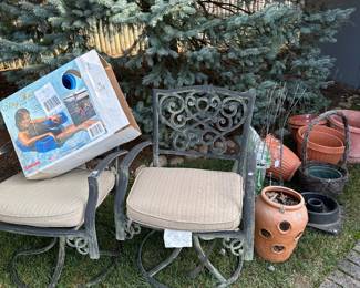 Two more patio chairs and assorted planters! Tomato Baskets and a nice floating pool seat in its original box!