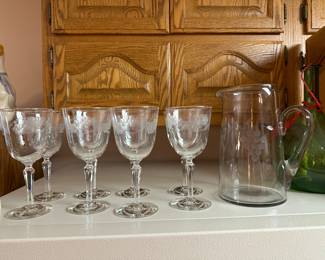 Back in the kitchen, we have a beautiful cut glass pitcher and goblet set! Grape Motif.