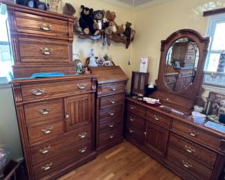 A beautiful SOLID OAK LEXINGTON Bedroom ensemble! A LARGE dresser with mirror, a Tall Boy Dresser w/cupboard, A night Stand, and a Tall undergarment dresser with makeup/jewelery mirror!
