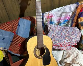 Nice guitar, cedar chest and some quilts!