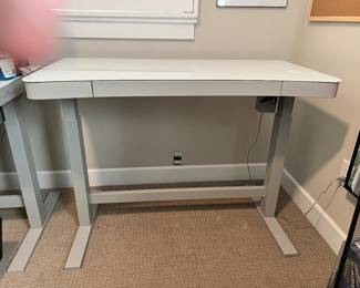Adjustable standing desk with phone charger 