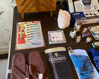 flip flops, Daisy advertisement, sewing box, Guinness mouse pad, paper napkins, salt lamp, Brother fax machine and printer ink, owl figurines, sand dollars