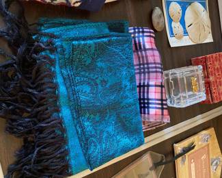 scarves, glass trinket dish, sand dollars, stone figurine in box