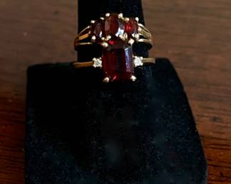 10k with red garnets, bottom ring has diamond accents.