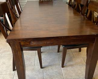 Kitchen dining table with six chairs. Measures length 6ft 2inches, width 3ft 6inches, with leaves total length 9ft 4inches