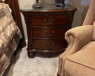 One of two cherry side bedside tables with three drawers