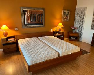 This is an overview picture of the nightstands, the king-sized bed, and the Dyrland lamps.  You can also see the painting or artwork on the wall above the headboard.