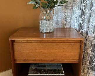 Another side table with a drawer can be seen here.  Don't forget the books and the flower vase.