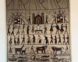 While we think the fabric is wool, we are more certain it is a woven wall hanging.  There is a wooden frame hiding behind the fabric.