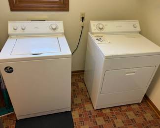 Whirlpool electric washer & dryer. Dryer vents outside.