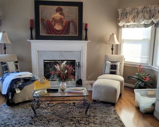 partial view of room with Henry Ascensio's Hand Embellished Limited Edition Canvas Giclee: entitled "Unveiling " absolutely gorgeous, beautifully framed work of fine art. The room is tastefully decorated with MCM matching chairs and ottomans, double door chest with 2 drawers, quality glass top coffee table , matching lamps and beautiful rug to compliment the decor