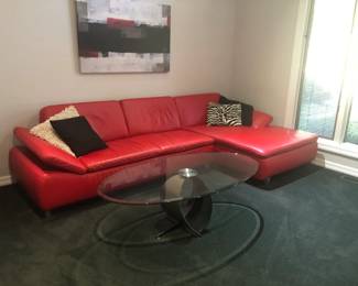 RED LEATHER SECTIONLAL ANDD OVAL COCKTAIL TABLE