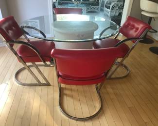 GLASS TOP TABLE AND 4 RED LEATHER CHAIRS