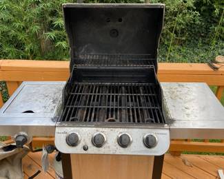 Charbroil four burner grill. In excellent functional condition. Could use some TLC on cleaning. Excellent grill grate. Sturdy. Makes great heat. I love cooking on this thing. It rocks. Better than those awful webers that won't sear. Includes good looking cover, two propane tanks and a propane gauge (those are worth $150 on their own). $150. 
