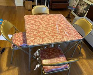 Vintage 1960s card table and chairs. Better looking in person than this picture. Very good looking gold color on the metal, pink and white patterned fabric that is in excellent condition as it is still in the original plastic (can remove plastic). Perfect condition. Back in style! $120. Have another set also, only one pictured herre. 