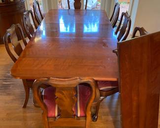 Dining table and chairs. 3 scratches on top of table. not terrible. Extra leaf for table pictured here. Huge table. Can add/remove the two leaves. Table is 43" wide and can be either 66, 86, or 106" long. Six chairs have no arms, and two have arms (intended for head of table). One of the armchairs has damage to an arm that can be repaired. $500 for the full set. 