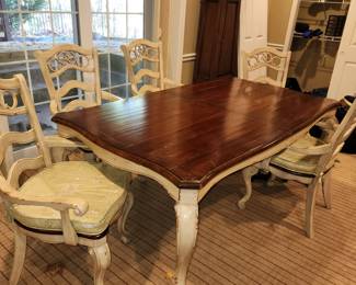 distressed wood painted base dining table with 6 matching chairs w/ cushions.  The chairs are sold with the table