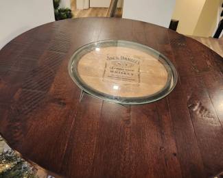 authentic Jack Daniels whiskey barrel table with metal footrail & glass top center