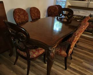 Henredon dining table with two 18" leaves and pads.  Elephant head/trunk style legs.  Pictured with 10 chairs by Century