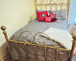 Beautiful brass double size bed with wonderful covers and Georgia Bulldog pillows