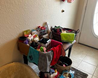 Assorted dog harnesses, coats,  collars,  leashes, car seat , toys , etc.  Harnesses & coats are size small