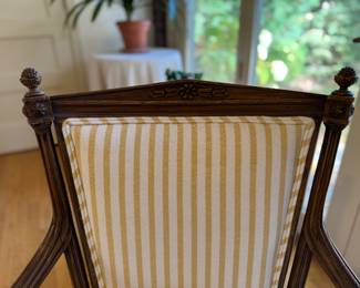 Pair of French Provincial Fireside Arm Chairs with Hand-Carved Acorn Finials. Chairs Are Upholstered in Yellow & White Stripe Cotton Fabric with Coordinating Trim. Each Measures 25" W with 9" Seat Depth. Photo 2 of 5.