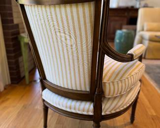 Pair of French Provincial Fireside Arm Chairs with Hand-Carved Acorn Finials. Chairs Are Upholstered in Yellow & White Stripe Cotton Fabric with Coordinating Trim. Each Measures 25" W with 9" Seat Depth. Photo 5 of 5.