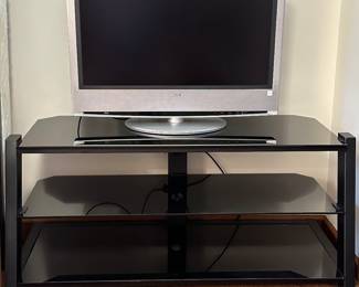 A beautiful Sony Flat Screen TV w/remote and Black Glass TV Stand! 