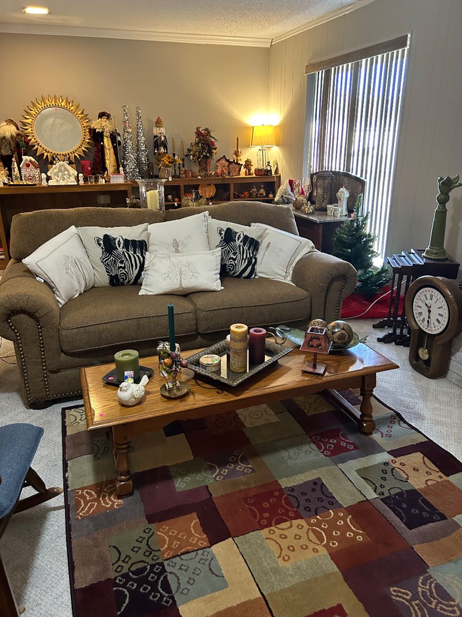 Beautiful couch, coffee table, rug, clock, nesting tables