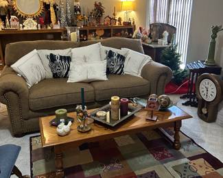 Beautiful couch, coffee table, rug, clock, nesting tables