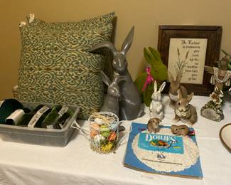 More pillows, picture,  rabbits, wire basket with artificial eggs & pillows. 