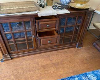 Television table with glass front for electronics 