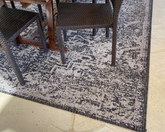 Table on patio with chairs - rug also for sale