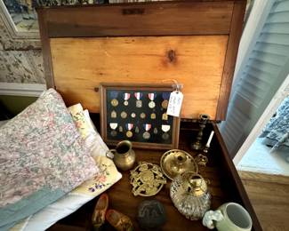 This is a framed box of medals from the 1920's, along with some brass pieces and inside the writing desk 