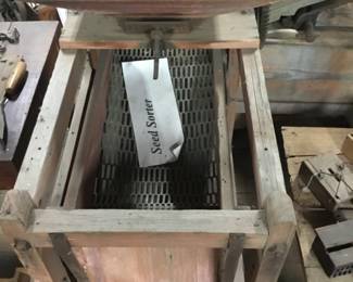 164. Lots of antique farm equipment. Seed sorter.