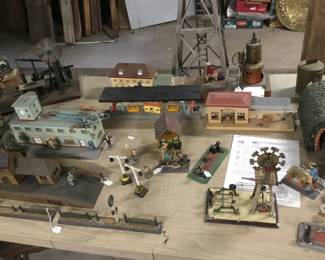 55. Tin toys, train stations, gates, people