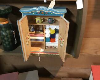 124. Small hand made cabinet. Shown holding thread and sewing fabric.
