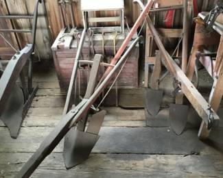 227. Lots of farm tools, plows, ladders,