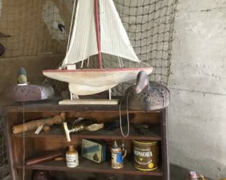 71. Sailboat and small containers. Duck decoys, fishing net