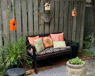 Outdoor sitting area; birdhouses; decor and planter; metal chair
