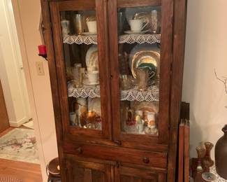 China cabinet full of glassware; lusterware; dishes