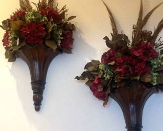 Wall sconces with floral arrangements