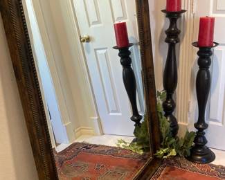 Large mirror; tall candlesticks and red candles