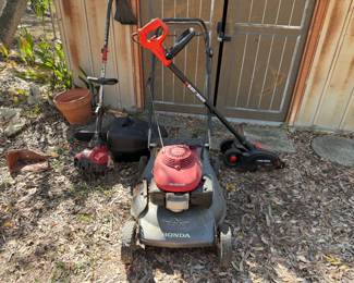 Honda Lawn Mower, Gas Weed Trimmer, Black and Decker Edger, and Electric Chain Saw