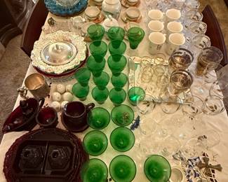 Various formal glassware including punch bowl and glasses, glass and silver platters, gold rim shot glasses and whisky sour glasses, red glass serving dishes, green stemware, English Beer mugs, Pewter mug along with coffee mugs, plates and flatware
