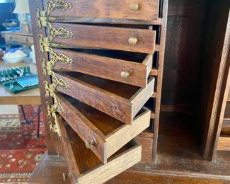 Antique oak dental cabinet with swing out drawers