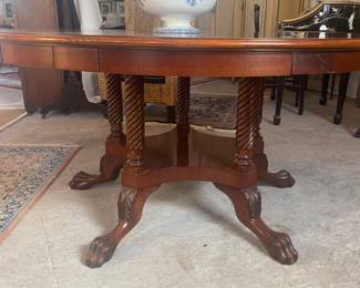 Round mahogany dining table w/5 crescent shaped leaves